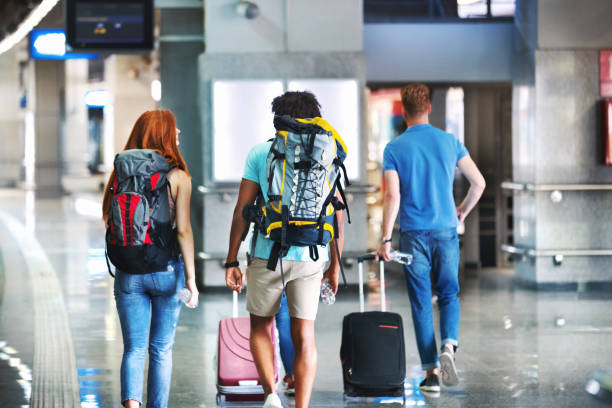 istock Group of young adults boarding a train. 1124233604