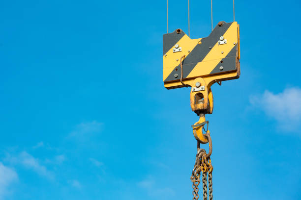 istock Crane load hook against the sky with trails and chain. 1124234019