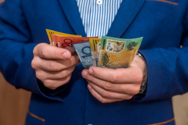 istock Male hands holding australian dollar banknotes, closeup 1124234780