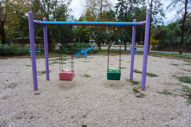 istock Empty colorful swings at the park 1124236425