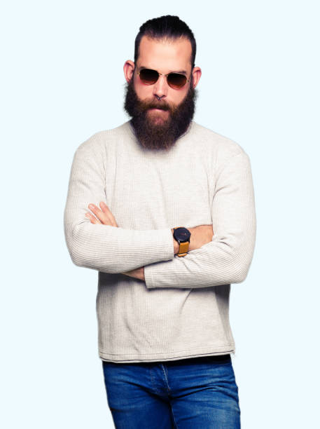 istock Young hipster man wearing sunglasses skeptic and nervous, disapproving expression on face with crossed arms. Negative person. 1124236558
