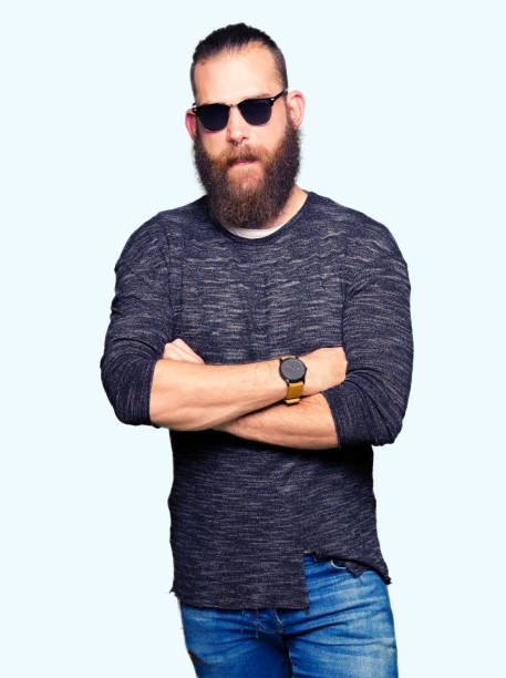 istock Young hipster man wearing sunglasses skeptic and nervous, disapproving expression on face with crossed arms. Negative person. 1124236560
