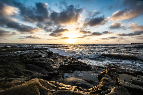 istock Rocky Pacific Ocean coastline at dusk with clouds 1124238127