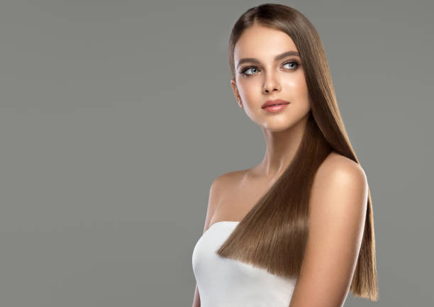 Young, brown haired beautiful model with long,  straight, well groomed hair. Hair care and hairdressing art. stock photo