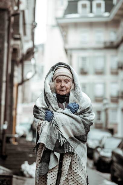 istock Sad serious aged woman closing her eyes 1124238424