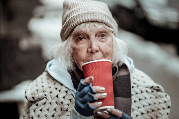 istock Sad poor woman standing with a cup of tea 1124238546