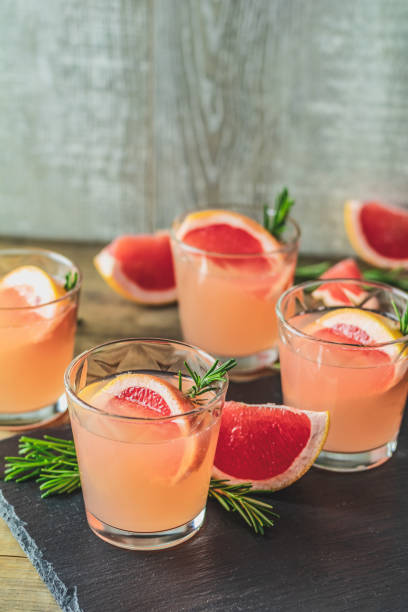 istock Pink alcoholic cocktail with grapefruit, ice and rosemary 1124240216