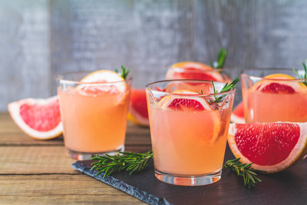 istock Pink alcoholic cocktail with grapefruit, ice and rosemary 1124240217