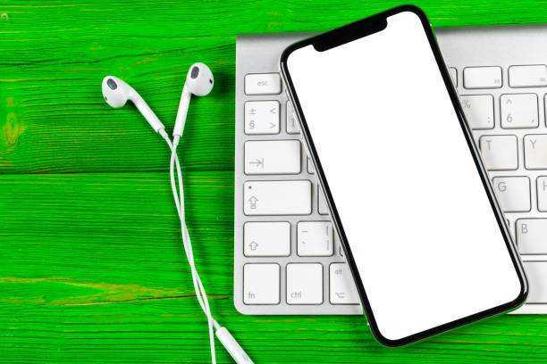 istock Smartphone with blank screen mock up. Smartphone isolated screen. Mobile phone white screen with copy space on computer keyboard. Empty space for text. Isolated white screen 1124240597