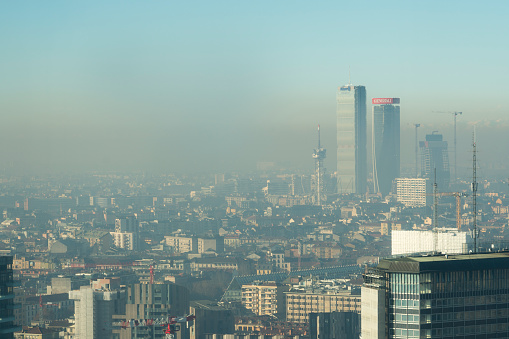 Milan, Italy - January 6, 2019: Milan landscape with smog, aerial view of the city with polluted air.
