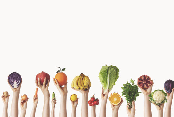 istock Hands holding different vegetables and fruits on isolated background 1124242433