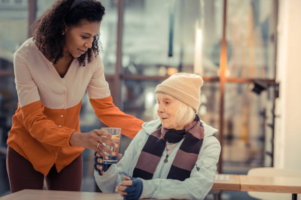 istock Nice elderly woman taking a glass with water 1124243060