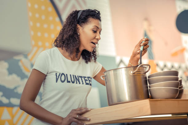 istock Joyful nice young woman preparing chicken broth 1124243137