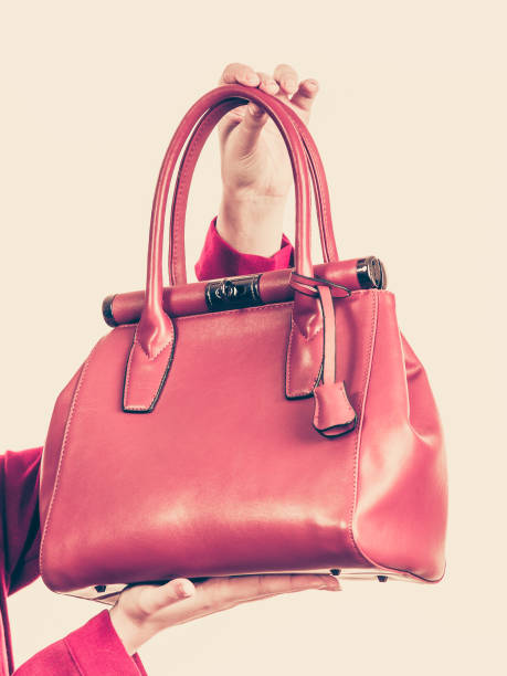 istock Female holding brown leather bag 1124243475