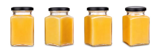istock Square jar of honey with black cap 1124247658