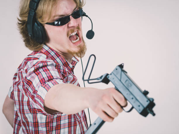 istock Gamer man shooting from gun 1124248618