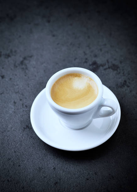 istock Cup of coffee on black stone background. Copy space 1124251455