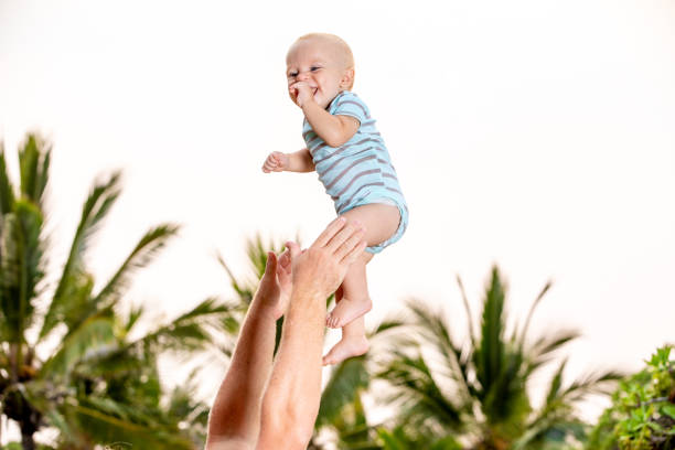 istock Father Tossing and Catching Son 1124251742