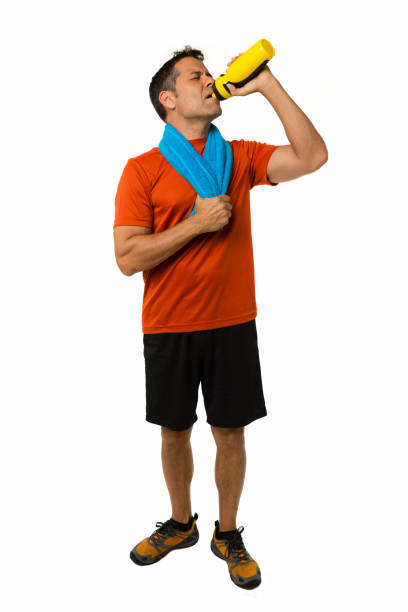 istock Full body shot of lean athletic man drinking water post workout 1124253323