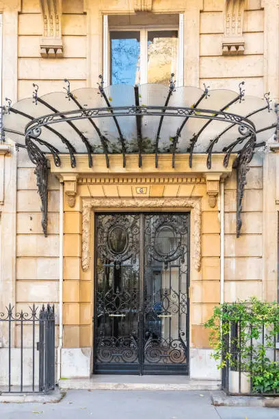 Paris, wrought iron door in a luxury avenue, beautiful entry porch