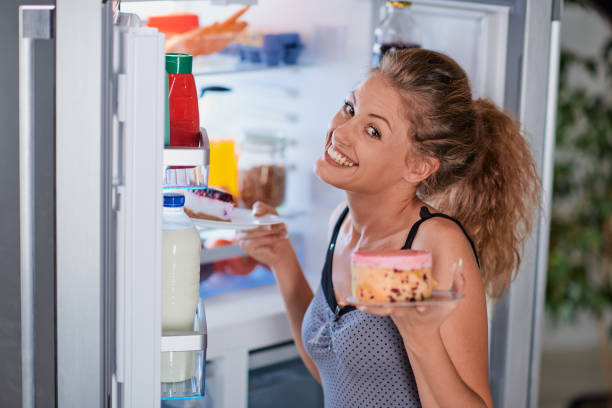 istock Woman taking cakes form fridge. 1124255942