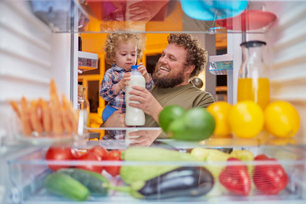istock Father and son taking milk from fridge in late hours. 1124256031