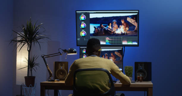 istock Young man sitting back and editing a video inside a room 1124258577
