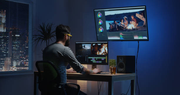 istock Young man sitting back and editing video inside a room 1124258613