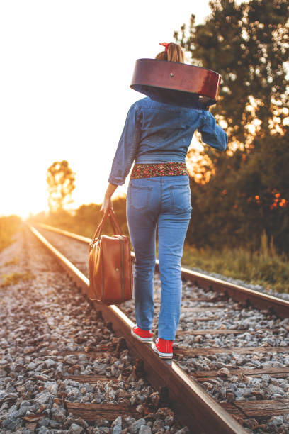 istock Woman walking on the railroad track 1124259667