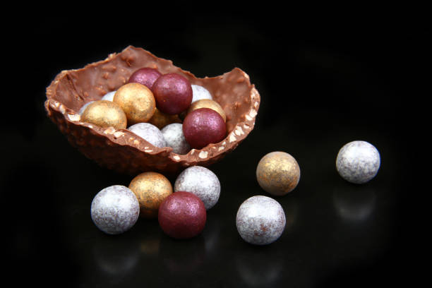 istock Modern sophisticated chocolate gold, silver & broze easter eggs, against a black background. 1124264729