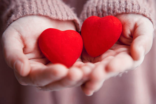 istock Female hands holding hearts.Valentine's day concepts 1124265478