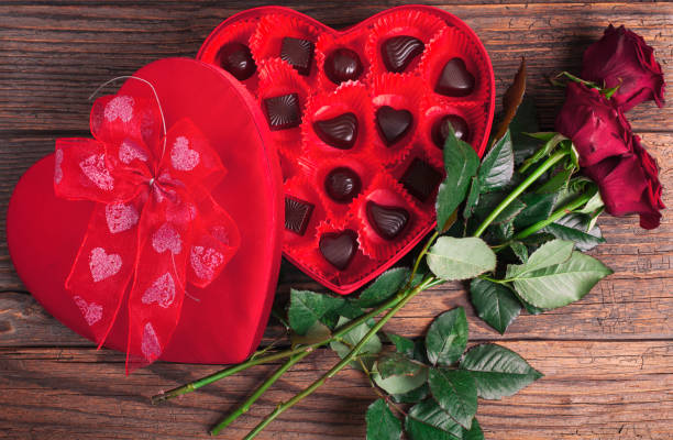 istock Heart chocolate box and red roses on wooden rustic background 1124269495