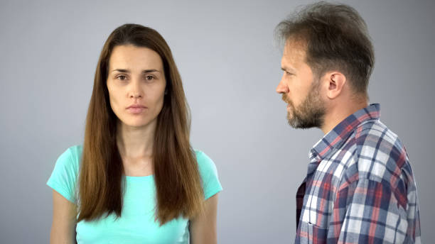 istock Upset wife looking into camera, man nearby 1124272659