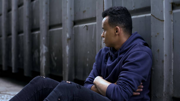 istock African-american homeless boy alone in hopeless situation, social problems 1124272824
