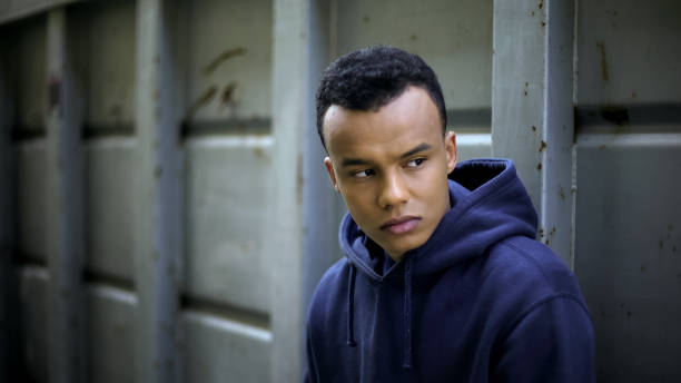 istock Frightened mixed-race boy looking around, hiding from everyone, bullying issue 1124272848