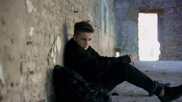 istock Teenager hiding from bullying in abandoned building, lonely, adolescent problems 1124272876