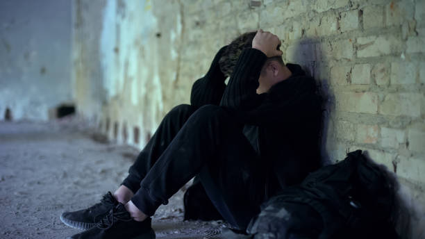 istock Adolescence problems, teen boy hiding in abandoned building, escape from bully 1124272920