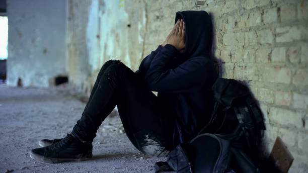 afro-americana muchacho escondido en el edificio arruinado, escapado de familia disfuncional - sadness teenager little boys depression fotografías e imágenes de stock