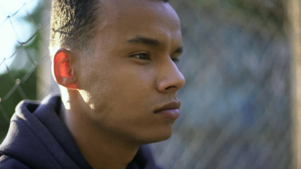 istock Afro-american teenage boy thoughtfully looking forward, concerned about future 1124273034