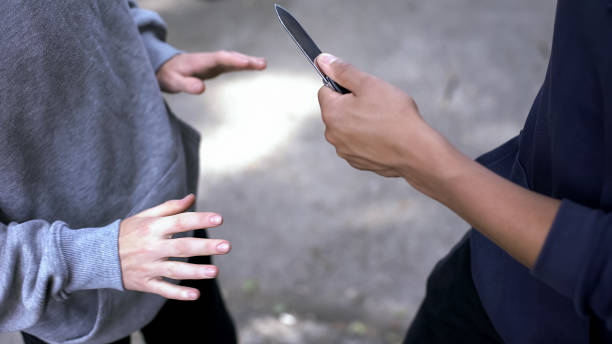 Afro-american criminal threatening male with knife, attacking victim, extortion