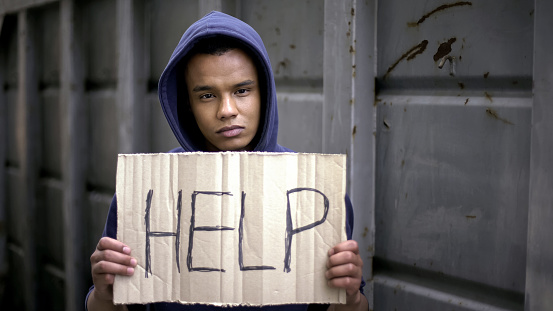 Help sign in begging afro-american boys hands, stop war, refugee problem