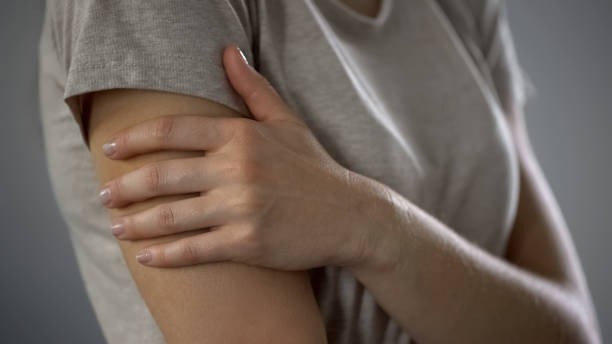 istock Lady touching hand, vaccination at hospital, infection prevention, immunization 1124273138