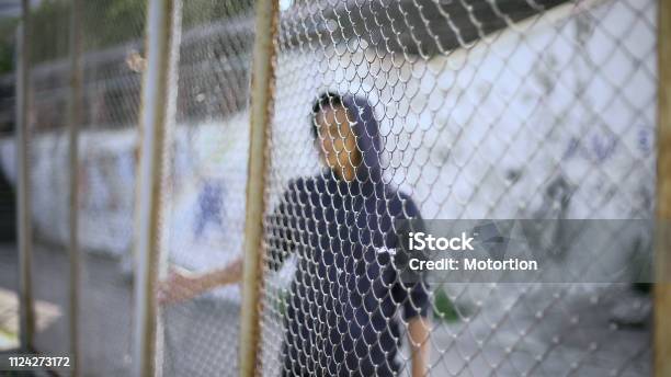 Afroamerican Boy Behind Fence Migrant Child Separated From Family Detained Stock Photo - Download Image Now