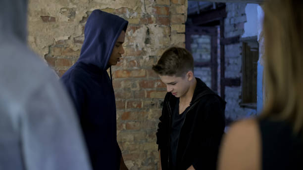 istock School bullies threatening junior, weakness, inability to protect oneself 1124274765