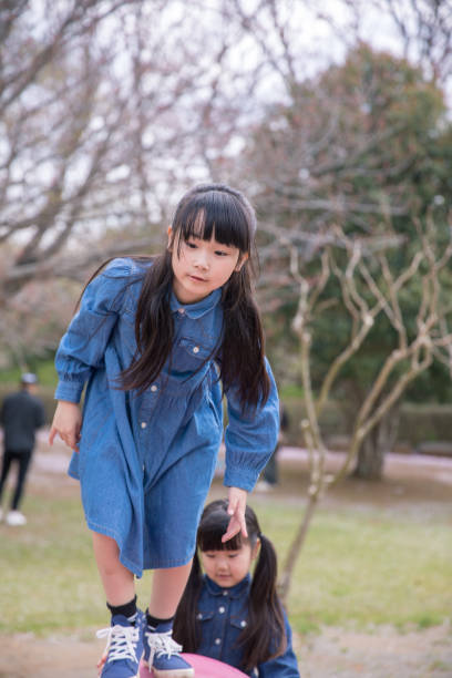 istock Little sisters playing in playground 1124277578