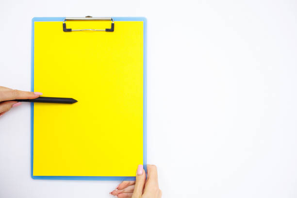 istock Blank Folder with Yellow Paper. Hand that Holding Folder and Handle on White Background. Copyspace. Place for Text 1124277599