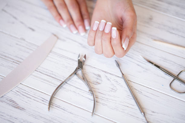 istock Manicure. Close up female hands situating on desk near nail tools 1124277897