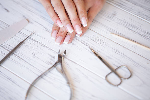 istock Manicure. Close up female hands situating on desk near nail tools 1124277907