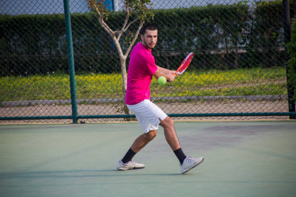 istock Young tennis player hitting the ball 1124277932