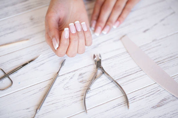 istock Manicure. Close up female hands situating on desk near nail tools 1124277977